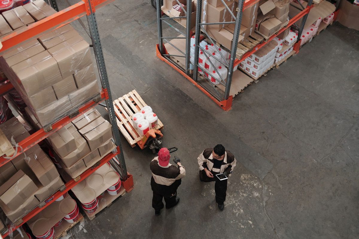 Warehouse staff sorting pallets in a distribution warehouse
